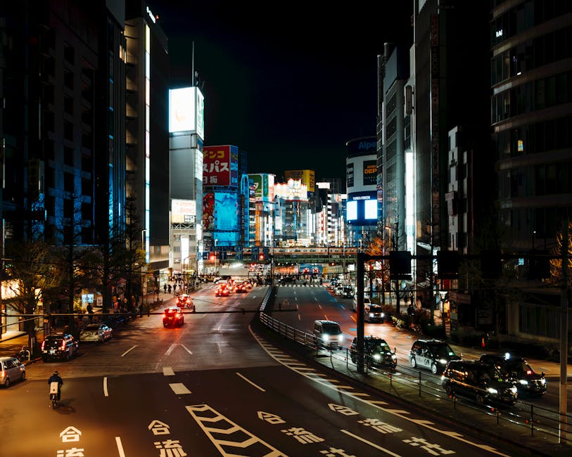 Explore the vibrant neon-lit streets of Tokyo at night, showcasing bustling urban energy.