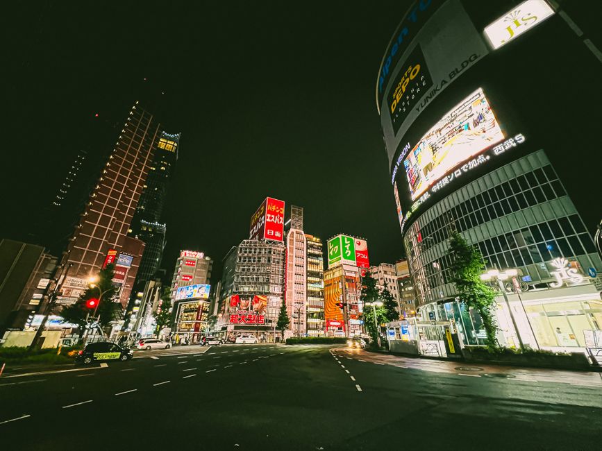 Explore the bustling streets and neon lights of Shinjuku, Tokyo at night.