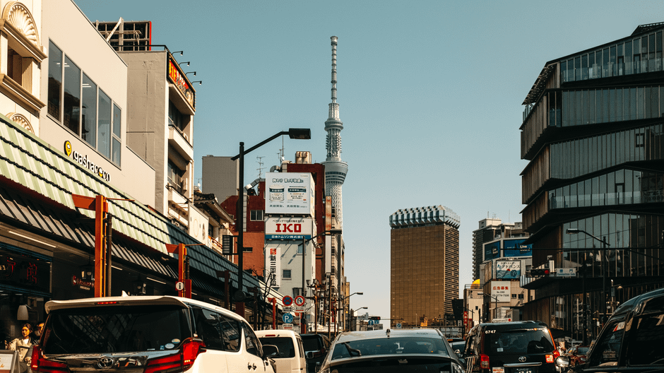 Bustling Tokyo street with the iconic Skytree and modern architecture. Daytime urban activity.